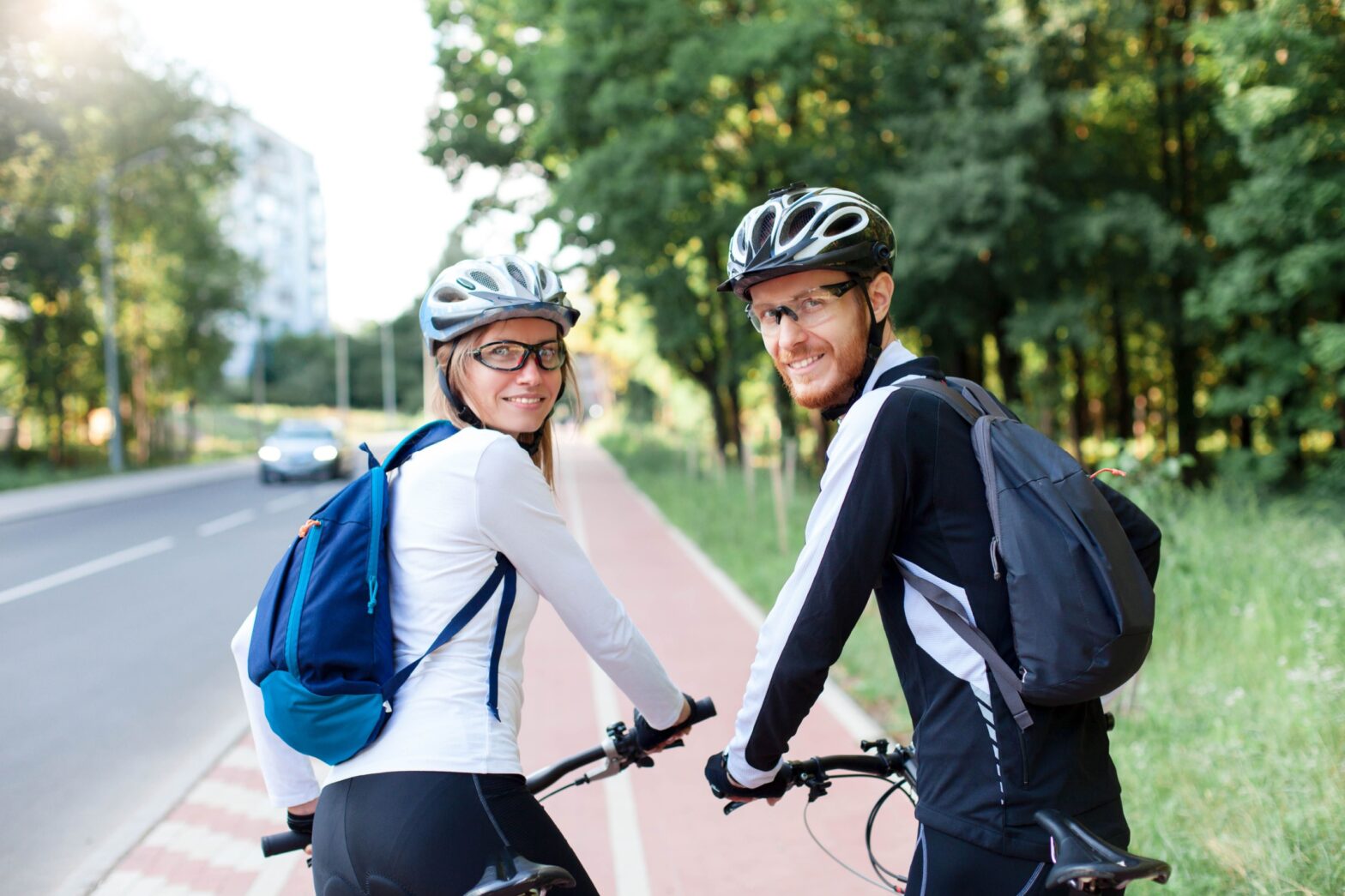 A couple wearing sports safety glasses while bicycling